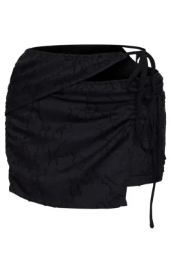 Online PrettyLittleThing Floral Applique Cut Out Wrap Over Micro Mini Skirt Black