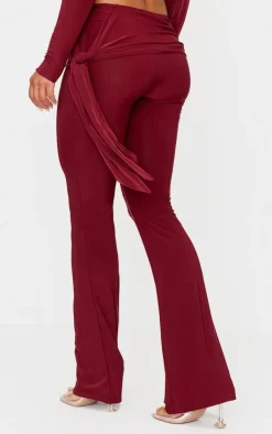 Online PrettyLittleThing Slinky Ruched Tie Detail Flare Pants Burgundy
