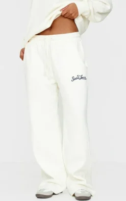 New PrettyLittleThing Contrast Embroidered Saint Louis Low Rise Wide Leg Sweatpants Cream