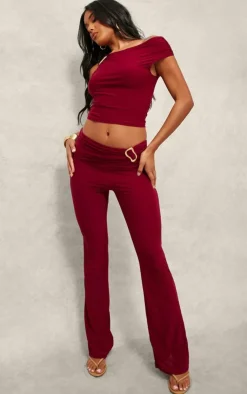 Discount PrettyLittleThing Slinky Fold Over Metal Trim Skinny Flare Pants Dark Red