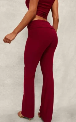 Discount PrettyLittleThing Slinky Fold Over Metal Trim Skinny Flare Pants Dark Red