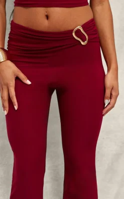 Discount PrettyLittleThing Slinky Fold Over Metal Trim Skinny Flare Pants Dark Red