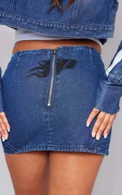 Hot PrettyLittleThing Graphic Panelled Denim Mini Skirt Mid Blue Wash
