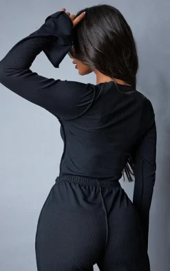 Online PrettyLittleThing Petite Ribbed Seam Detail Long Sleeve Top Black