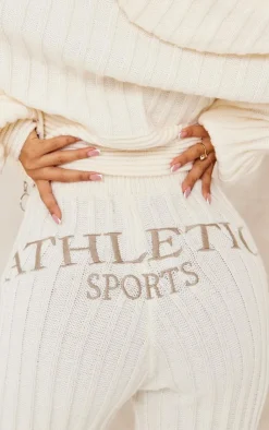 Best PrettyLittleThing Petite Athletic Sport Embroidered Knit Flared Pants Cream