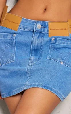 Petite Mid Blue Wash Denim Low Rise Badge Detail Mini Skirt