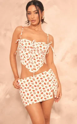Online PrettyLittleThing Petite Denim Strawberry Printed Low Rise Mini Skirt White