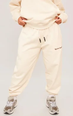 PrettyLittleThing Cream Sweatsuits*Premium Petite Sports Academy Puff Print Oversized Sweatpants