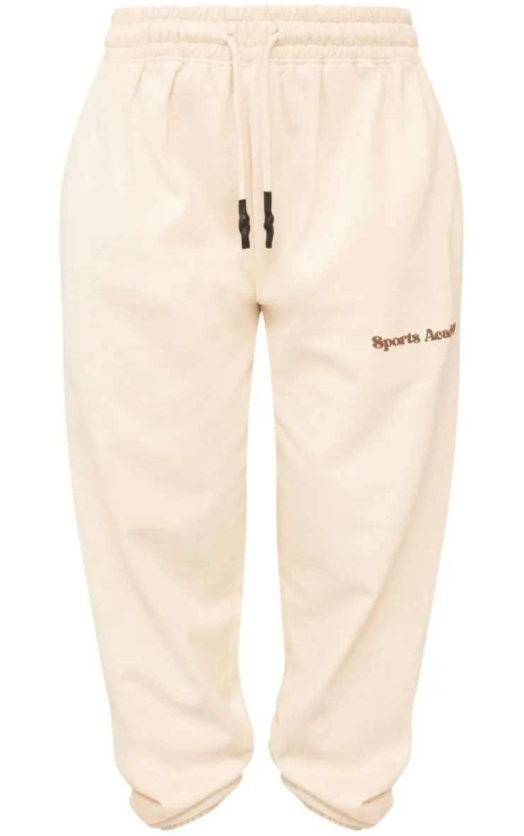 PrettyLittleThing Cream Sweatsuits*Premium Petite Sports Academy Puff Print Oversized Sweatpants