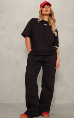 Online PrettyLittleThing Badge Detail Mid Rise Wide Leg Sweatpants Black