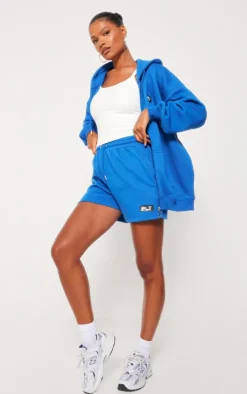 PrettyLittleThing Badge Oversized Runner Shorts Blue