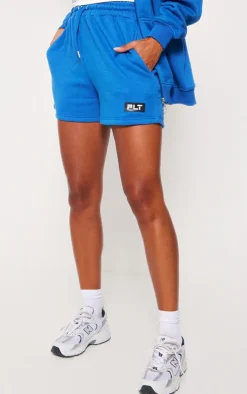 PrettyLittleThing Badge Oversized Runner Shorts Blue