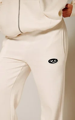 Online PrettyLittleThing Contrast Logo Badge Wide Leg Sweatpants Cream