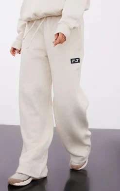 PrettyLittleThing Cream Sweatsuits*Petite Badge Detail Straight Leg Sweatpants