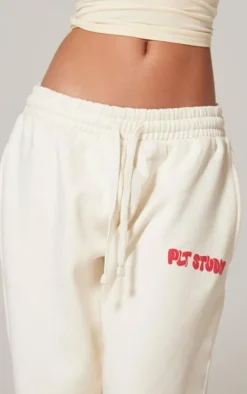 PrettyLittleThing Cream Sweatsuits*Premium Studio Print Straight Leg Sweatpants