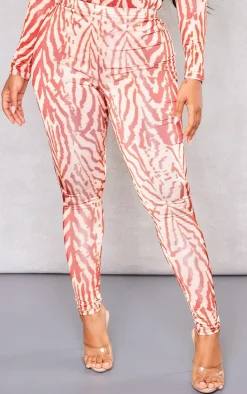 Online PrettyLittleThing Shape Printed Slinky Leggings Orange