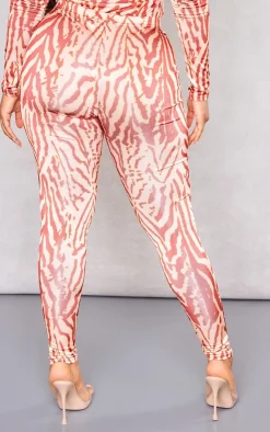 Online PrettyLittleThing Shape Printed Slinky Leggings Orange