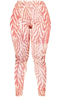 Online PrettyLittleThing Shape Printed Slinky Leggings Orange